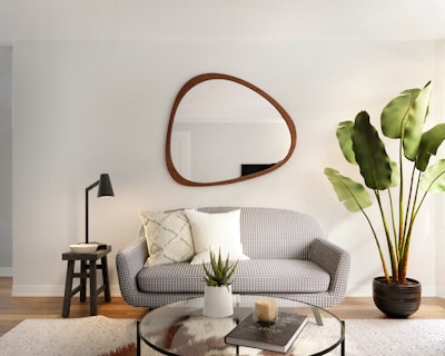 a living room filled with furniture and a mirror