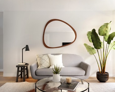 a living room filled with furniture and a mirror