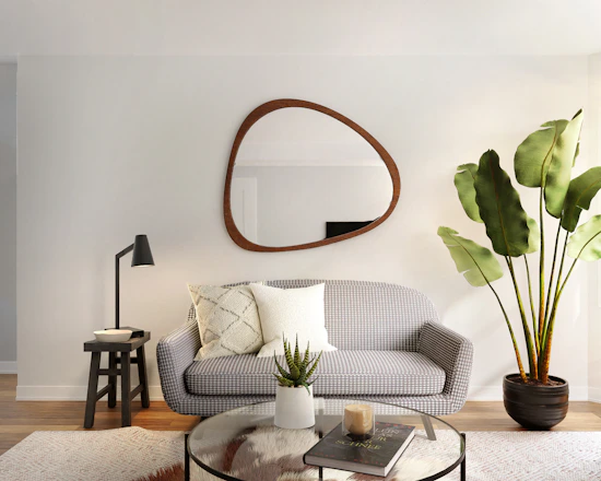 a living room filled with furniture and a mirror