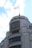A large, elegant building with a prominent logo, featuring modern architecture and a rooftop proudly displaying a national flag.