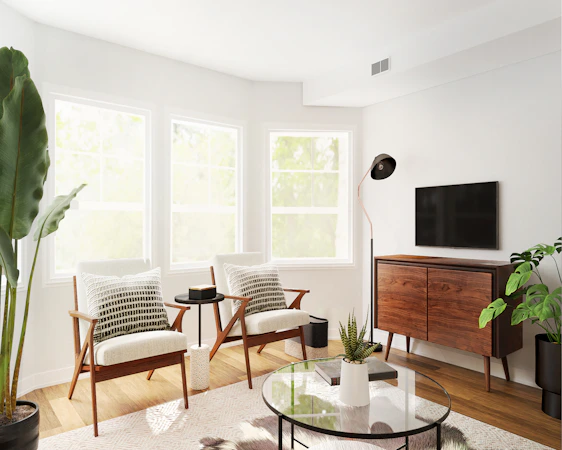 A cozy living room featuring a mid-century teak coffee table paired with an aluminum lounge chair bathed in natural light.