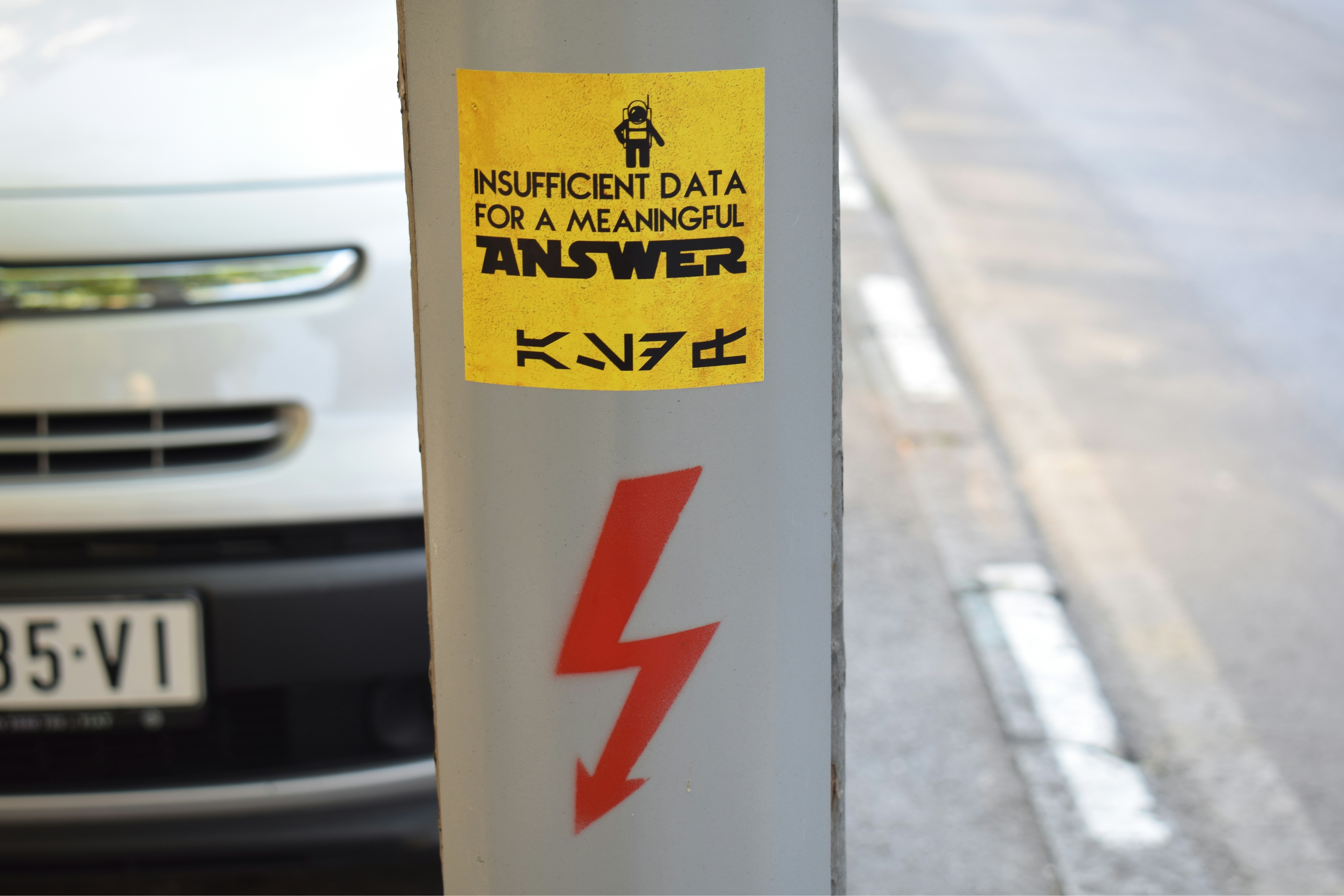 Technician holding a tablet showing an electric car’s battery health diagnostic report
