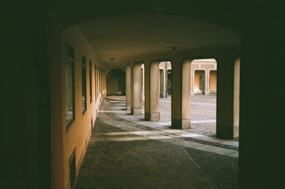 a hallway with columns and a clock on the wall