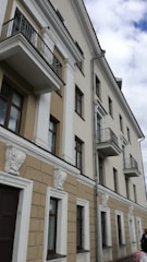 Elegant residential facade with decorative cornices and moldings.