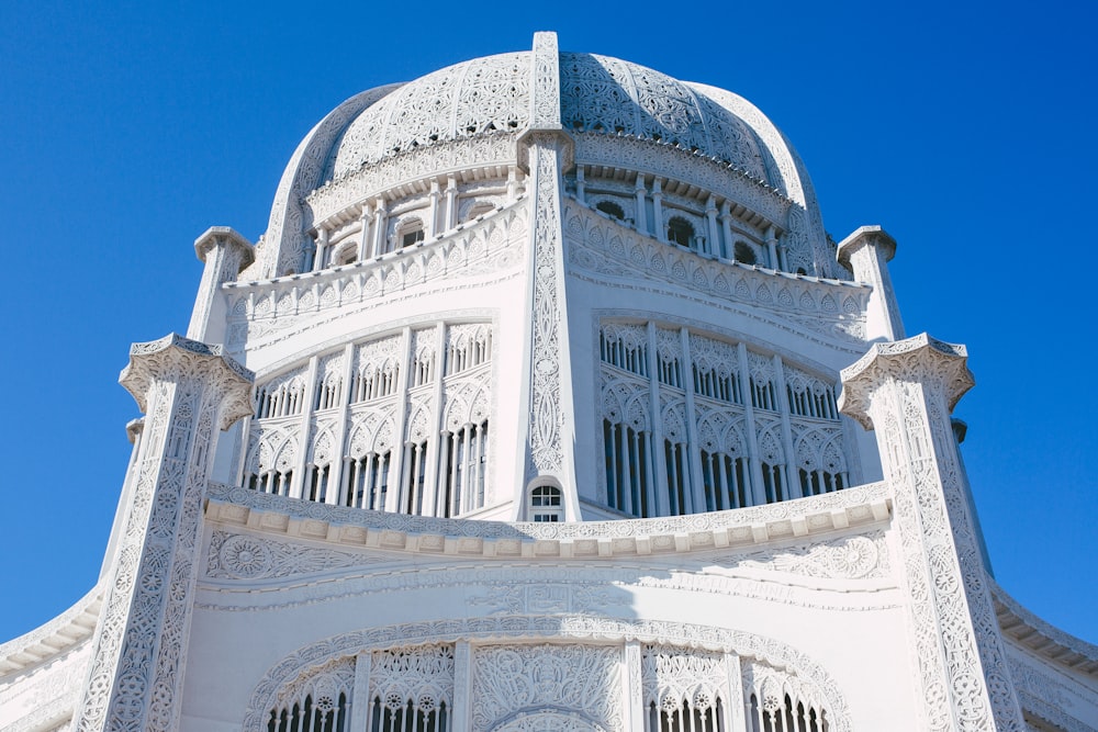 a large white building with a blue sky in the background