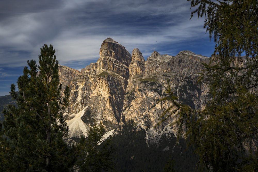 a view of a mountain range with trees in the foreground