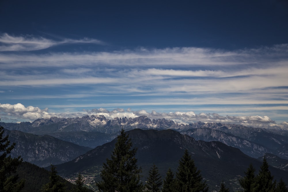 a view of a mountain range with clouds in the sky