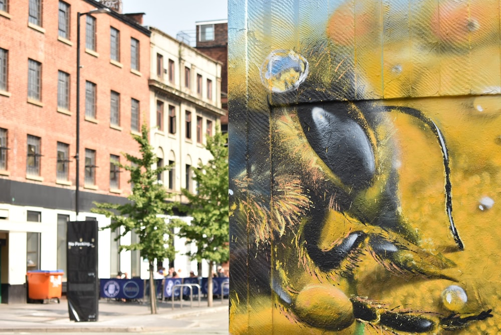 a painting of a bee on the side of a building