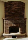 a brick fireplace in a corner of a room