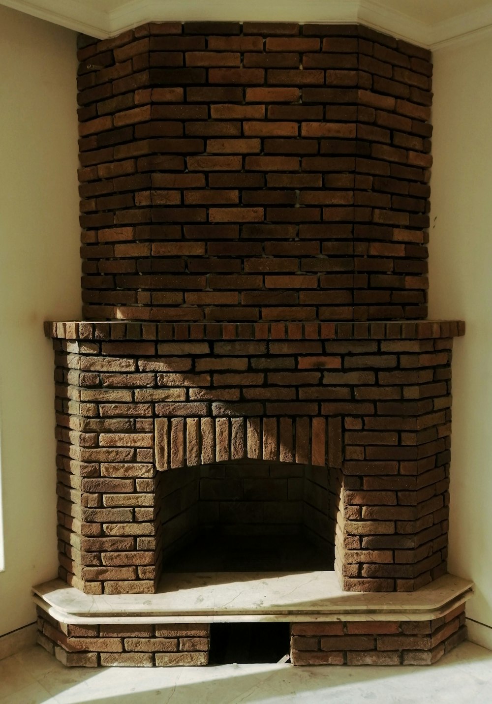 a brick fireplace in a corner of a room
