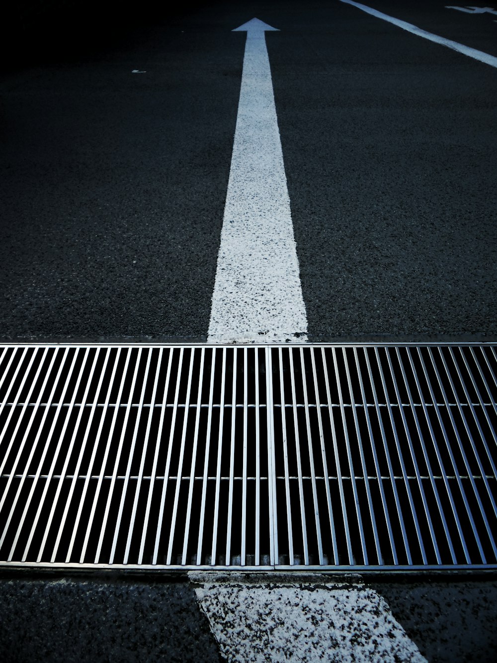 a metal grate on the side of a road