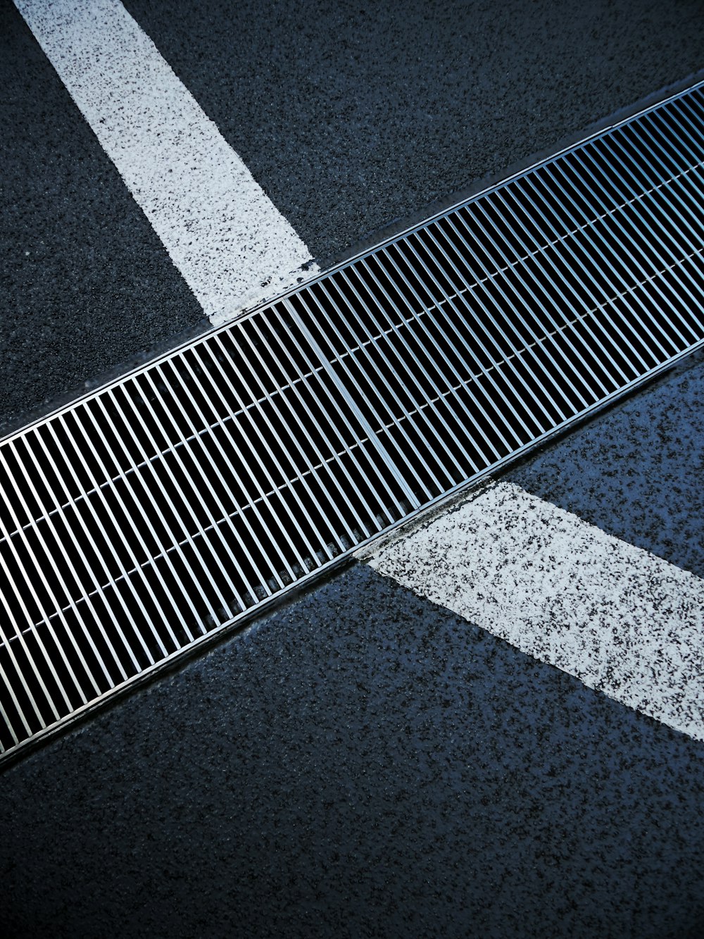 a metal grate sitting on the side of a road