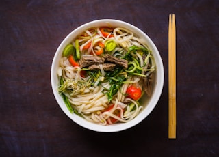 Pho Bo - Vietnamese fresh rice noodle soup with beef, herbs and chili. Vietnam's national dish. Top view