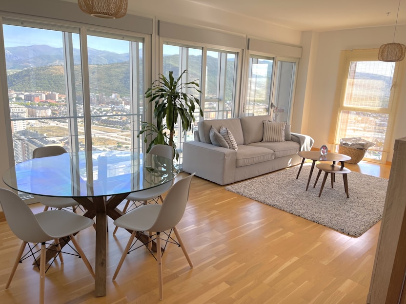 A modern glass table set in a stylish living room.