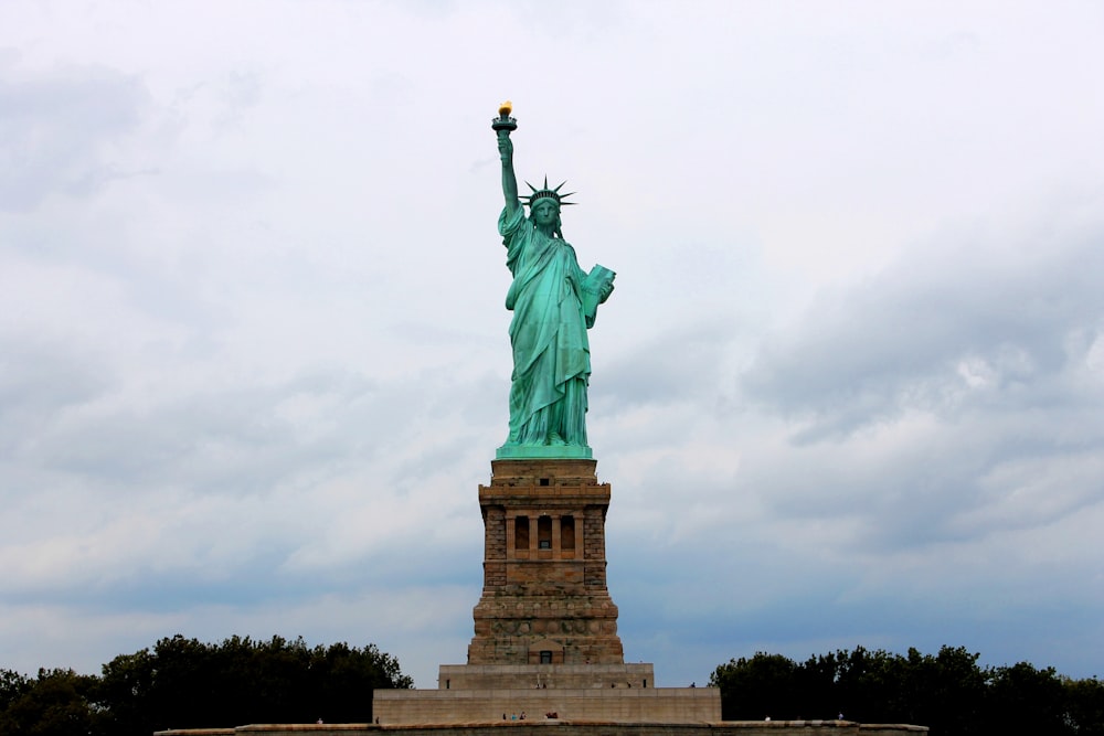 the statue of liberty is surrounded by trees