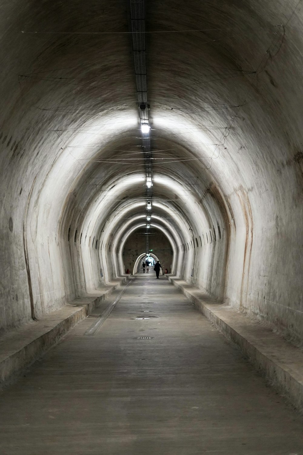 a long tunnel with a person walking down it