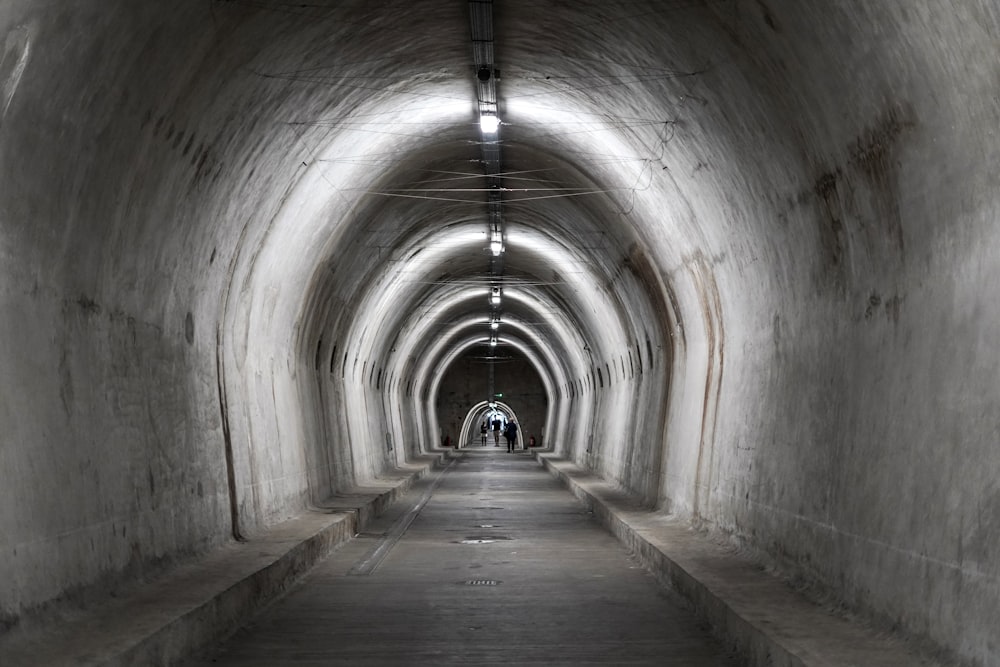 a long tunnel with a person walking down it