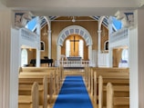 a church with a blue carpet and a blue runner