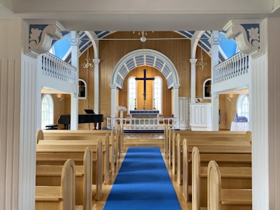 a church with a blue carpet and a blue runner
