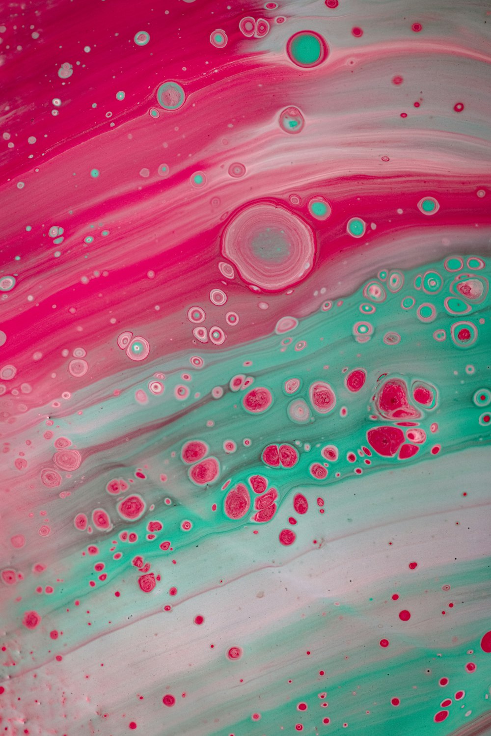 a close up of a pink and green liquid