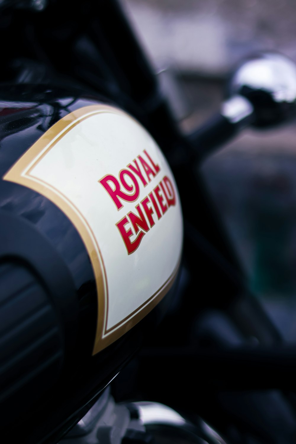 a close up of the royal enfield logo on a motorcycle