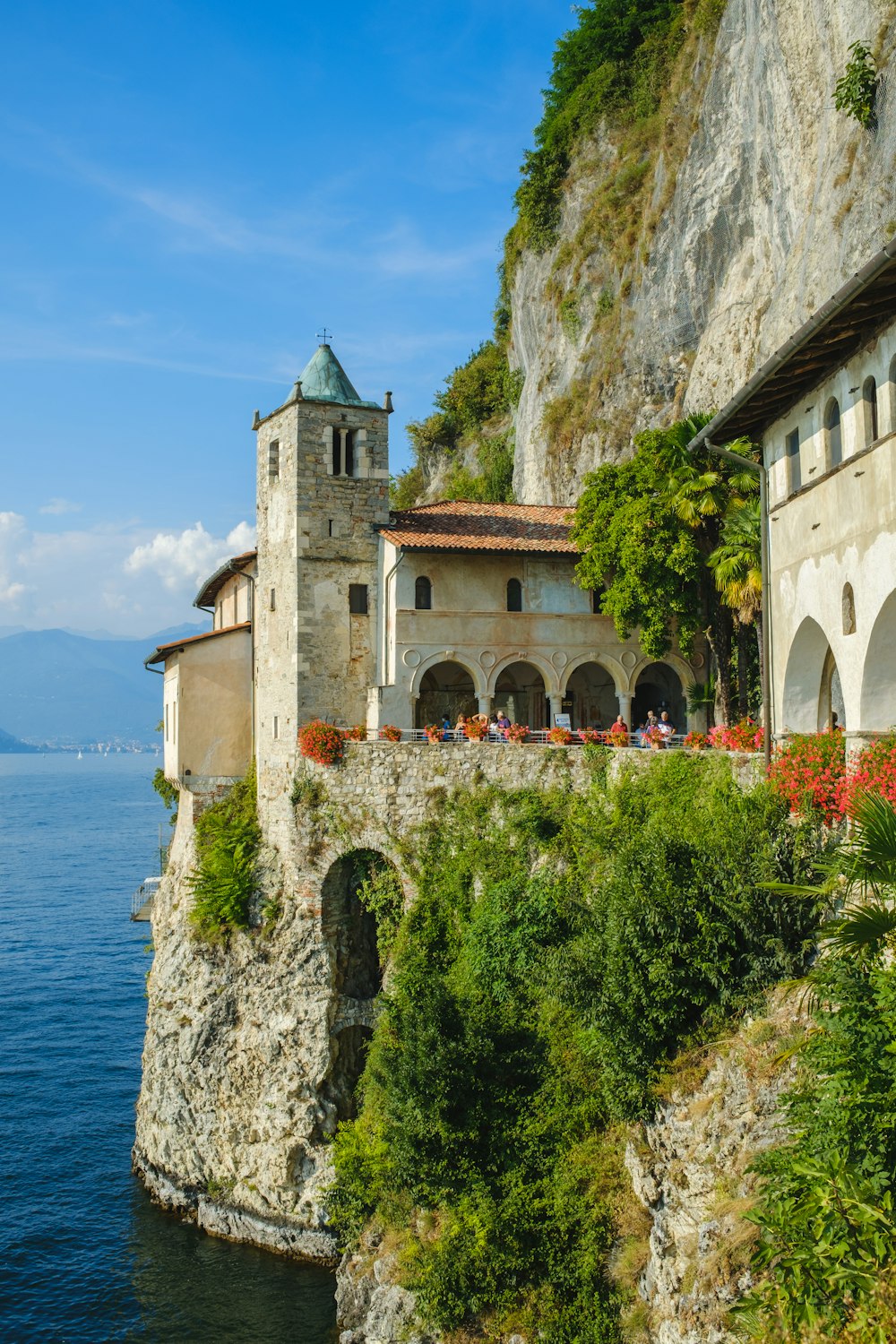 a building on the edge of a cliff next to the ocean