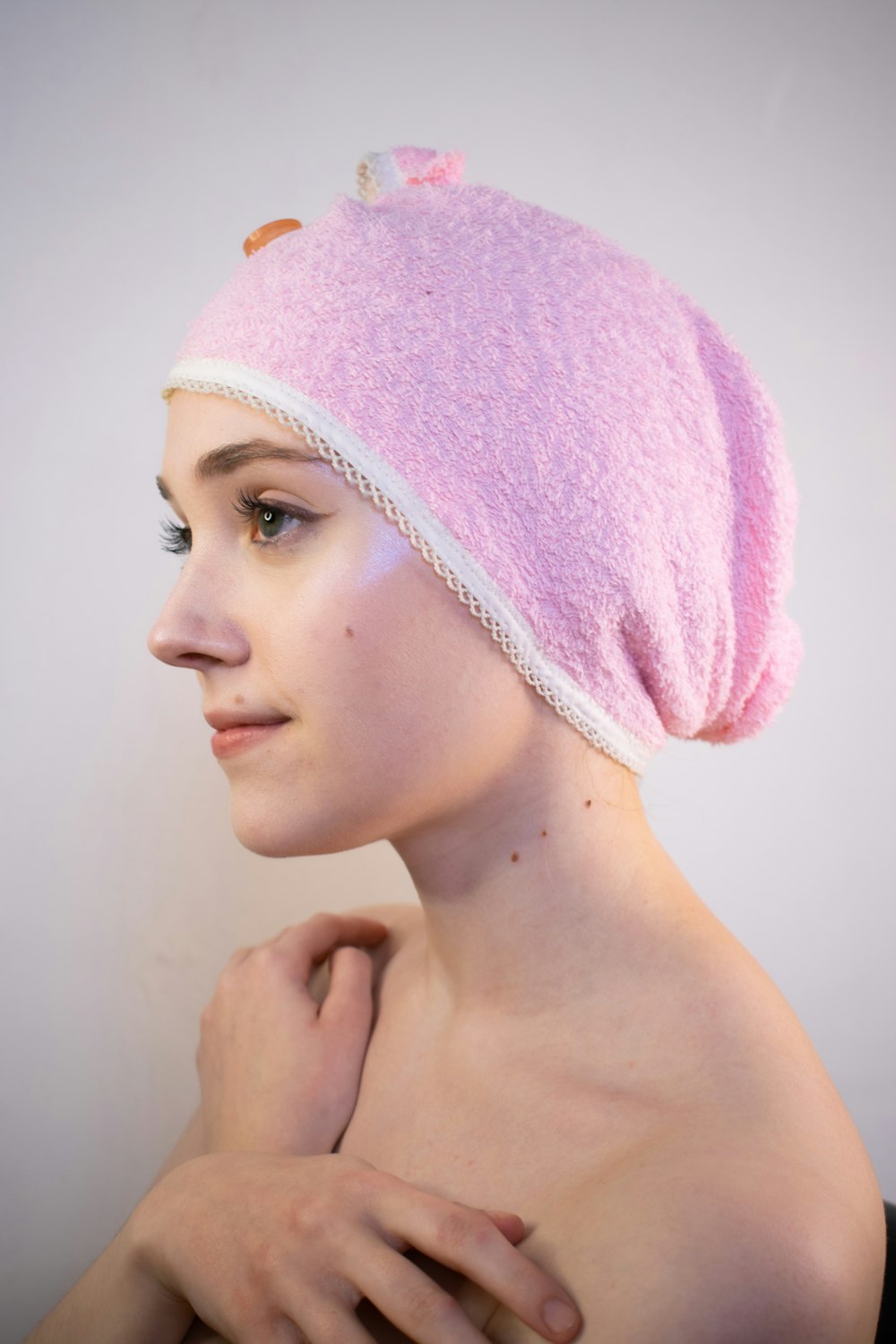a woman with a pink towel on her head