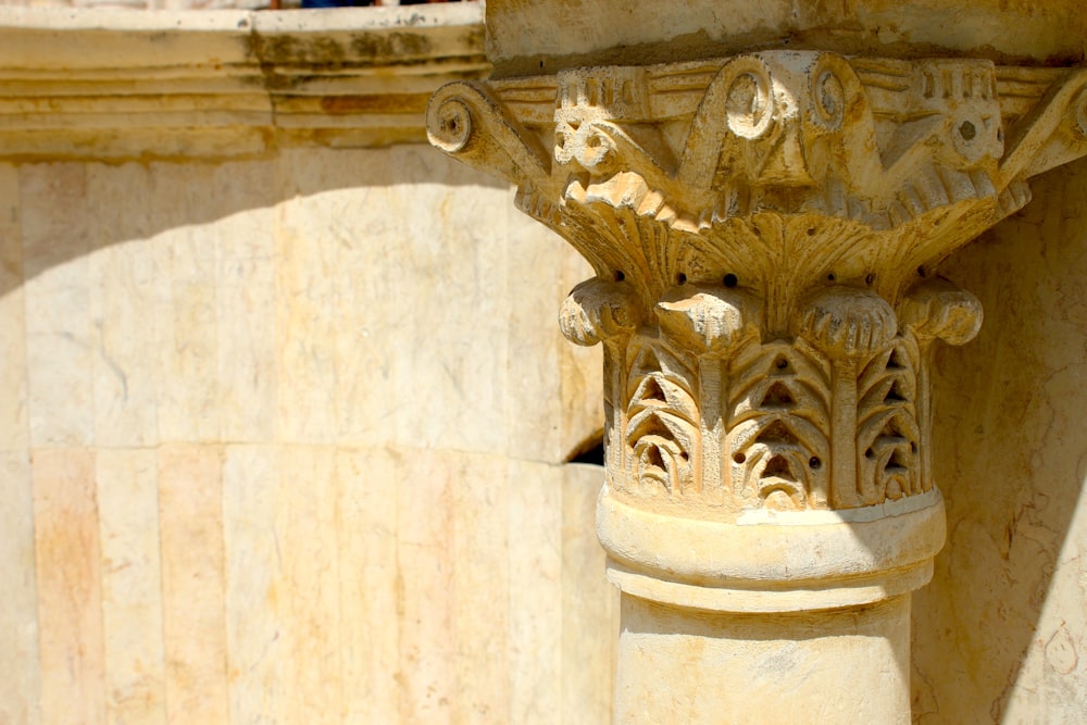 a close up of a pillar with a bird on it