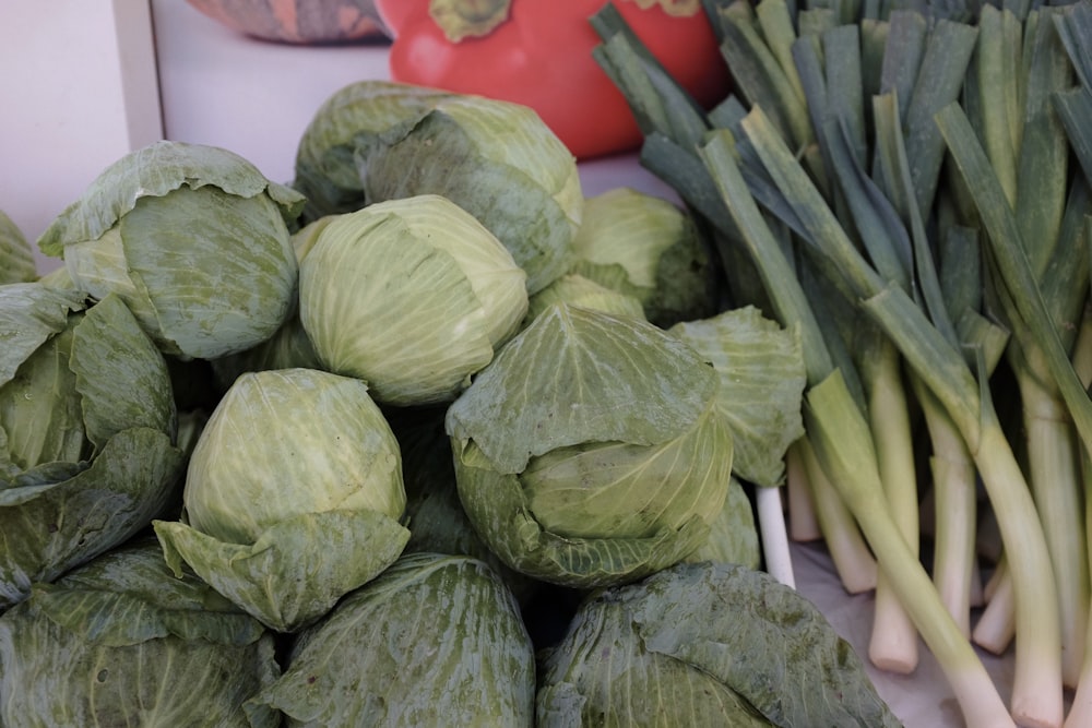 a pile of cabbage next to a pile of green onions