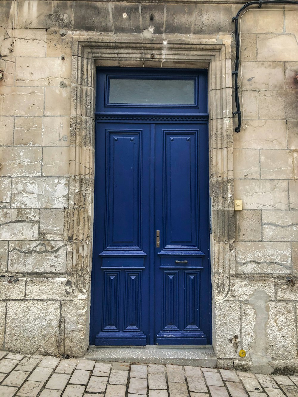 a blue door is on a stone building
