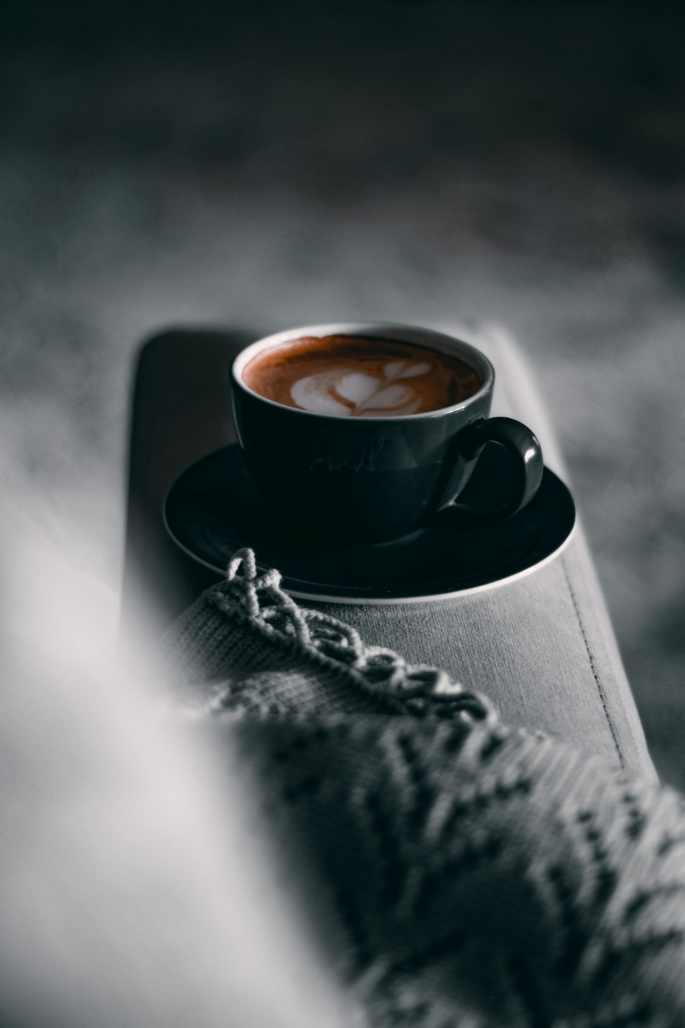 a cup of coffee sitting on top of a book