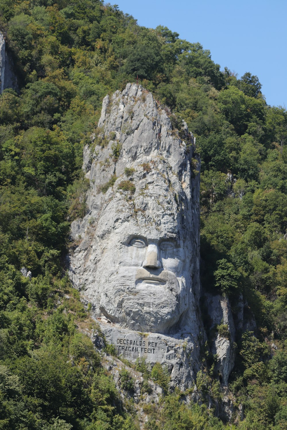 a large face carved into the side of a mountain