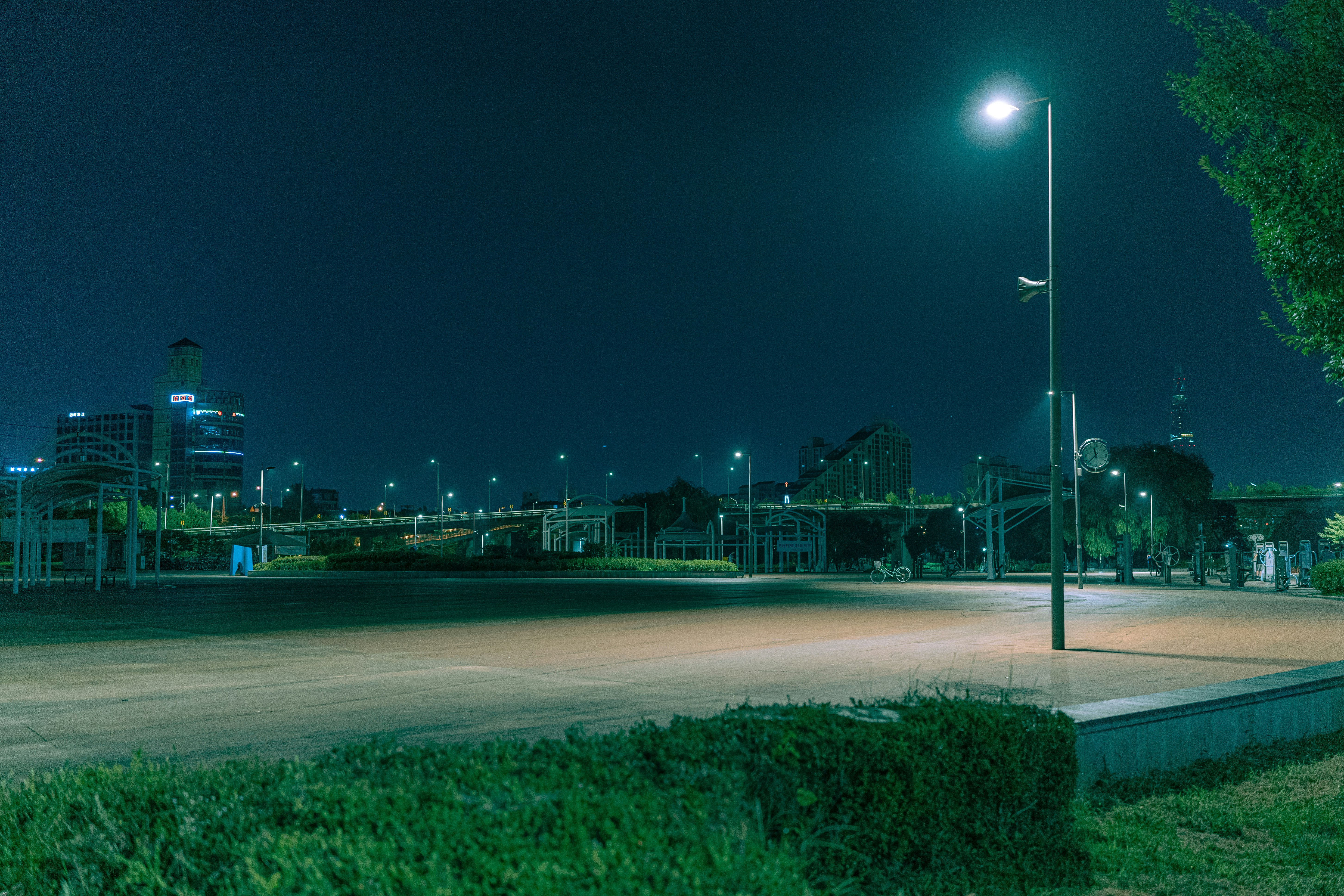 an empty parking lot in a city at night