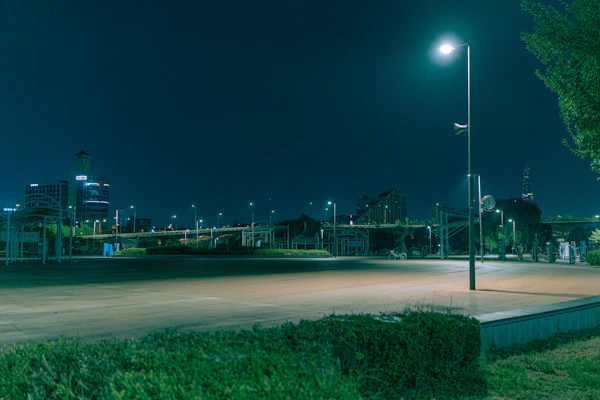 Open-air surface parking lot lit at night under the sky