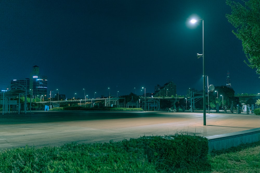 an empty parking lot in a city at night
