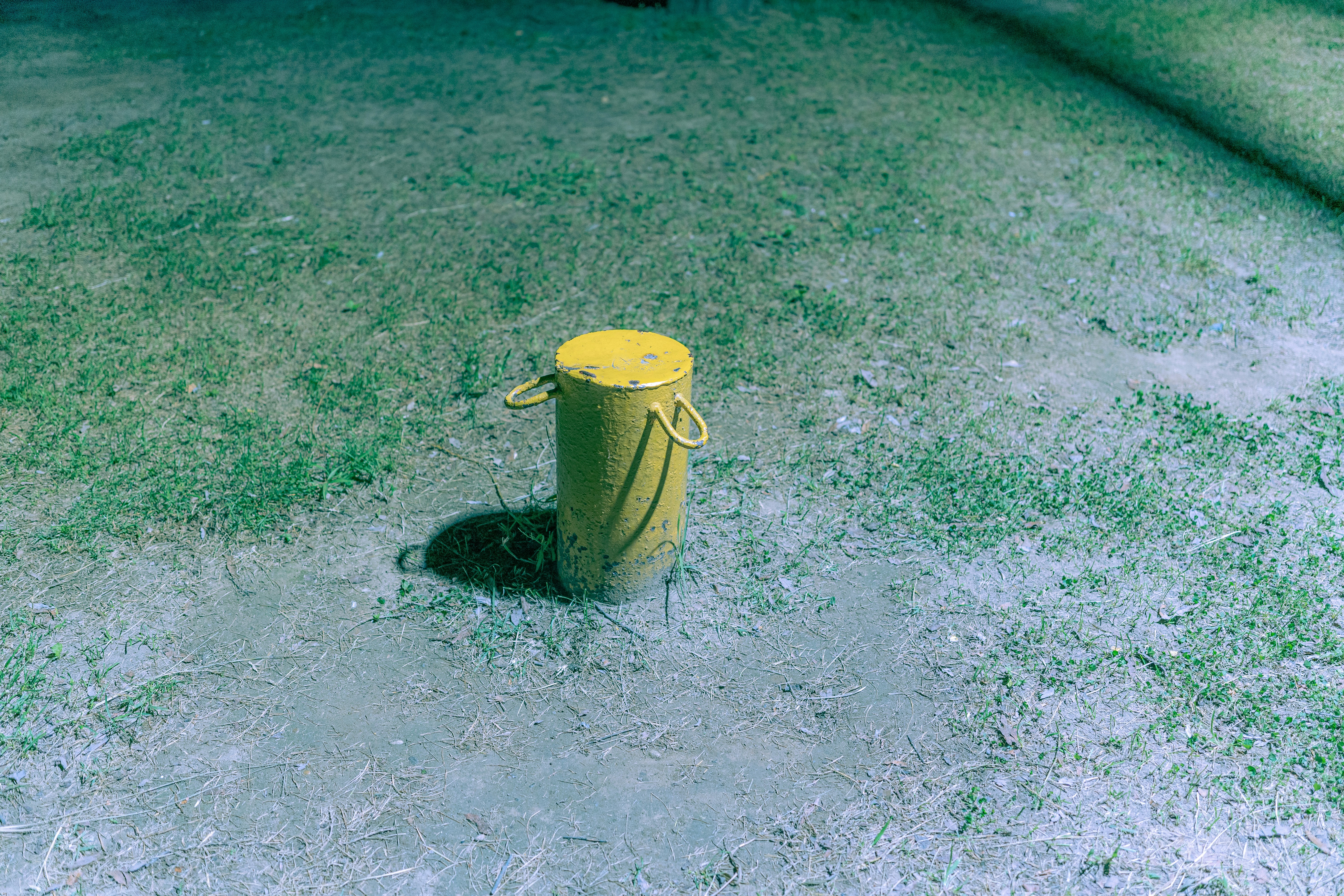 a yellow fire hydrant sitting in the middle of a field