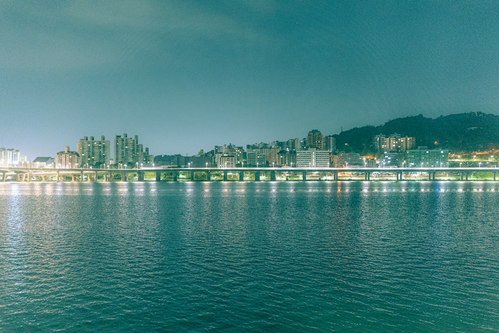 a large body of water with a city in the background