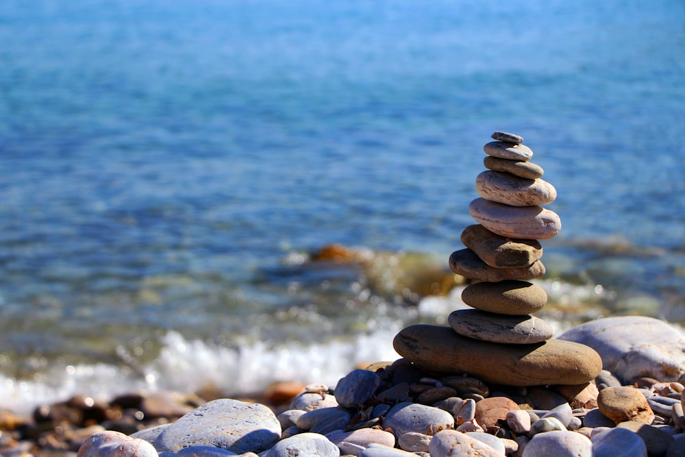 a pile of rocks sitting on top of a beach