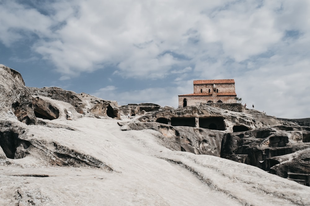 a small building on top of a rocky hill