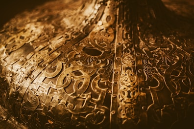 Intricate Kuber Yantra engraved on a brass plate with warm golden hues