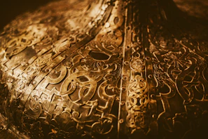 Close-up of a polished brass plate with intricate traditional Indian engravings