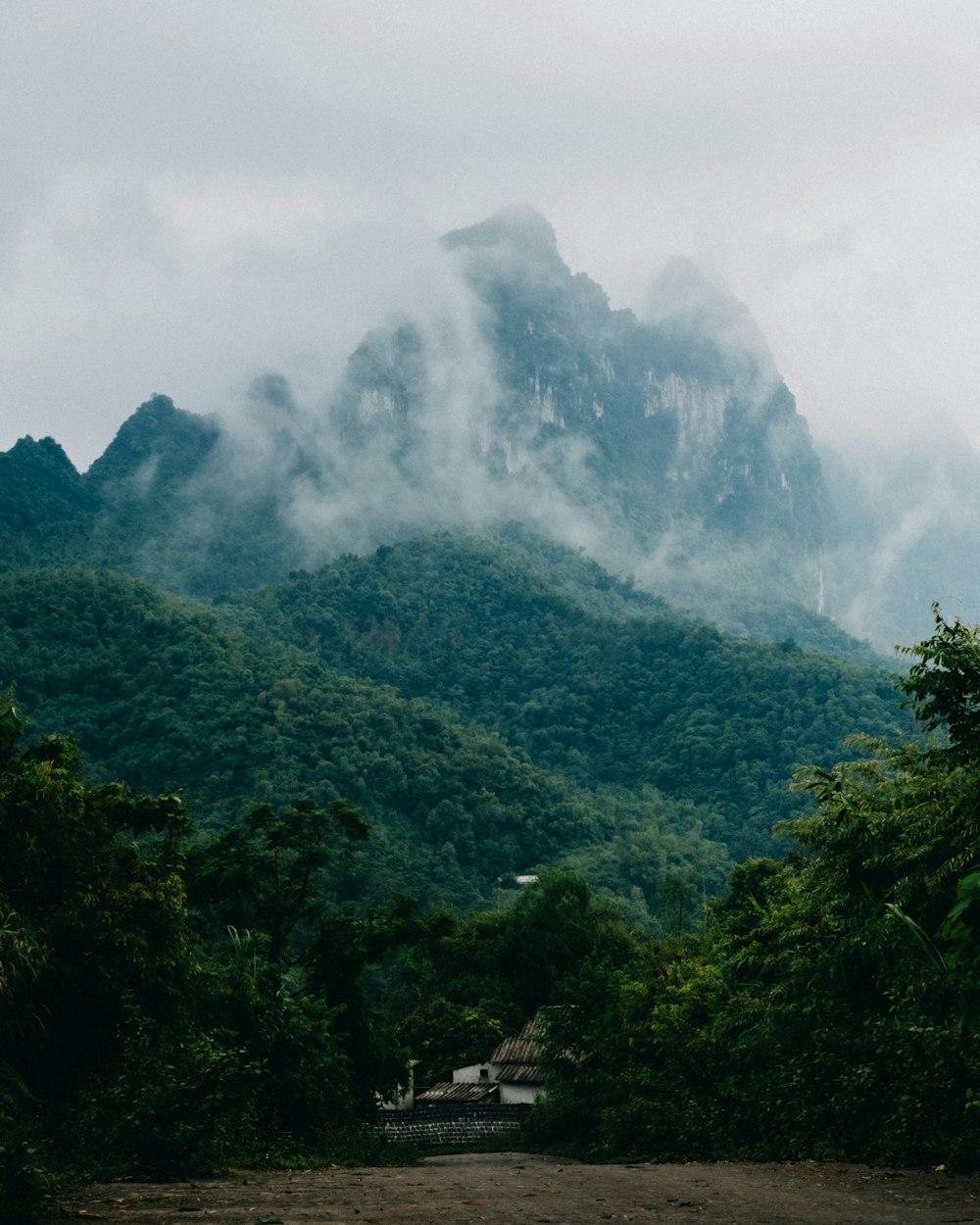 a view of a mountain covered in clouds