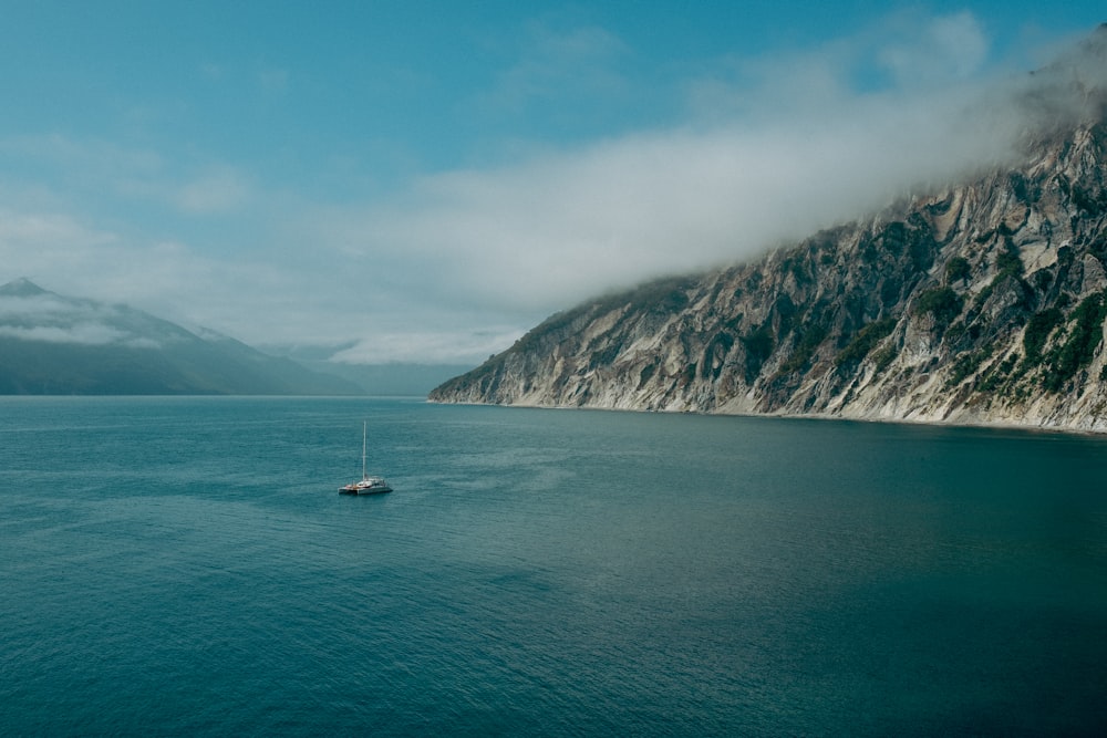 a boat floating in the middle of a large body of water