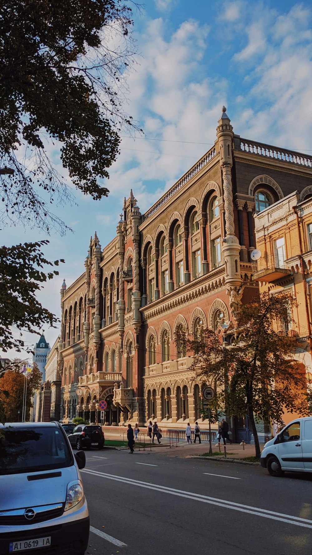 a large building on a street corner with cars parked in front of it