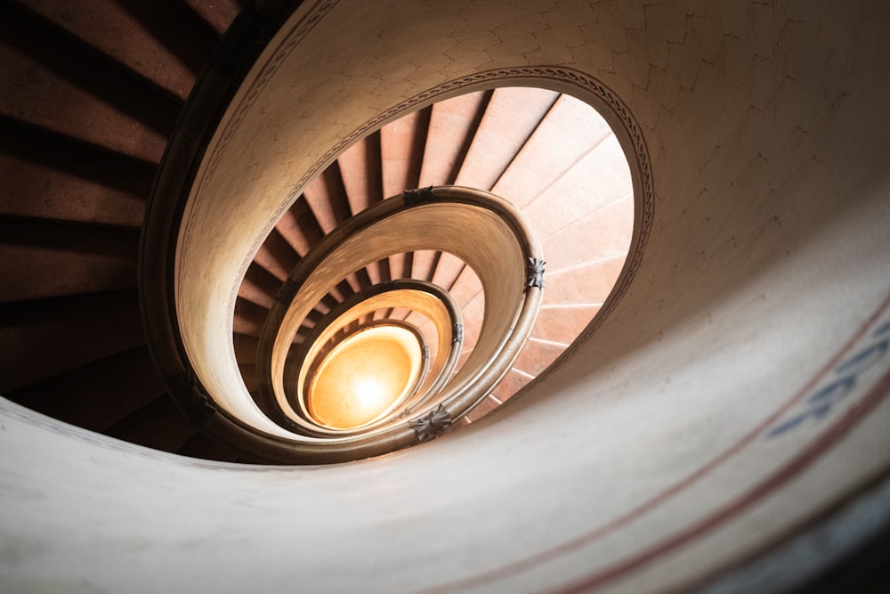 a spiral staircase with a light at the end