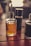 Close-up of natural cooking oils in glass bottles on a wooden table.