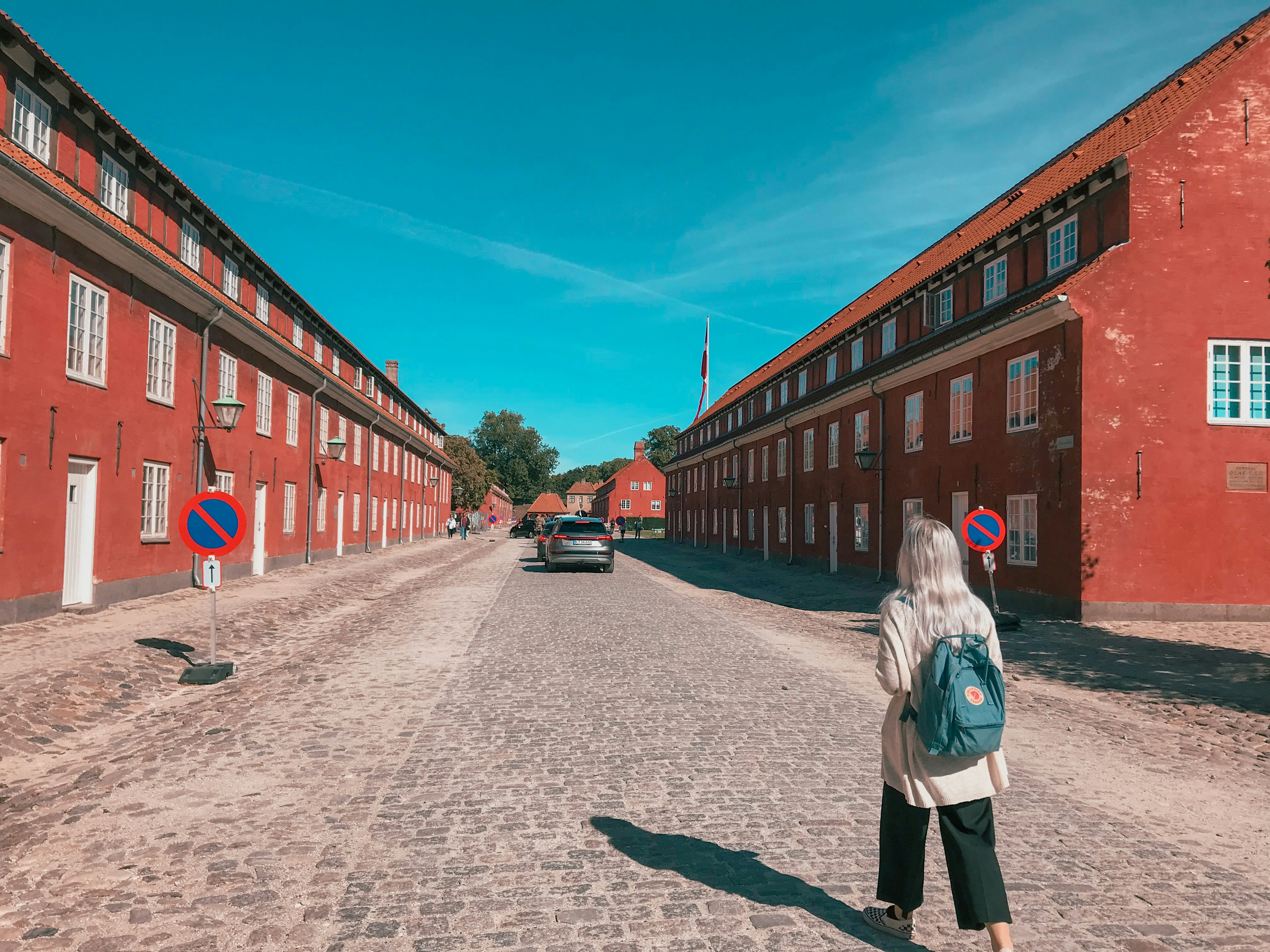 a woman standing in the middle of a street, Walking into