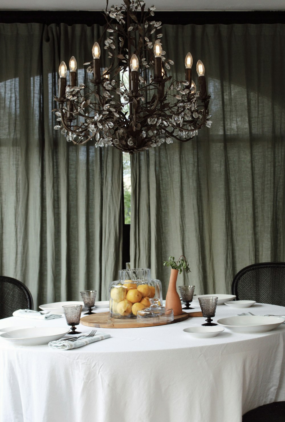 a dining room table with a tray of fruit on it