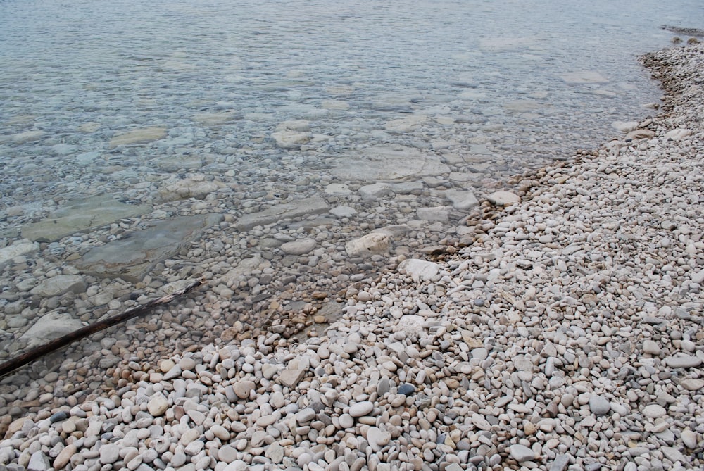 a body of water surrounded by rocks and gravel