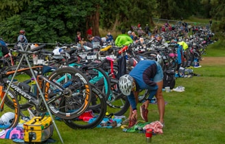 a group of people standing next to a bunch of bikes